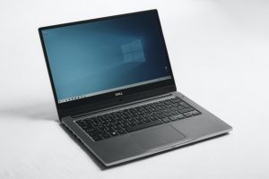 gray laptop with teal screen on white backround