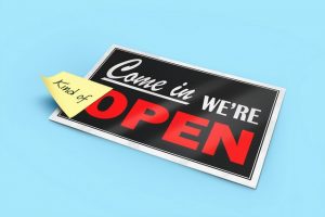 sign that says come in we're open with a sticky note that says "kind of"